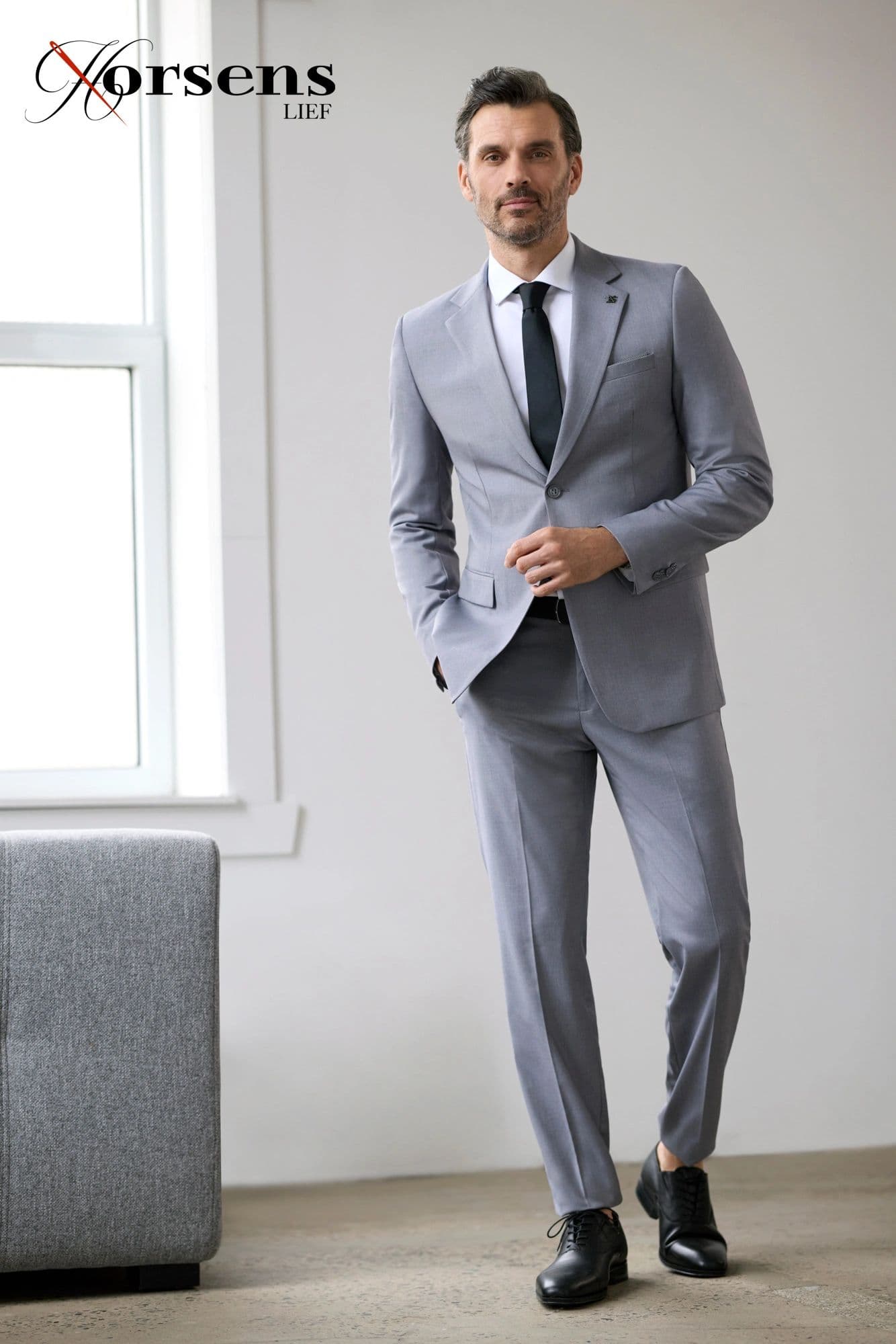 Light grey suit with a dark tie
