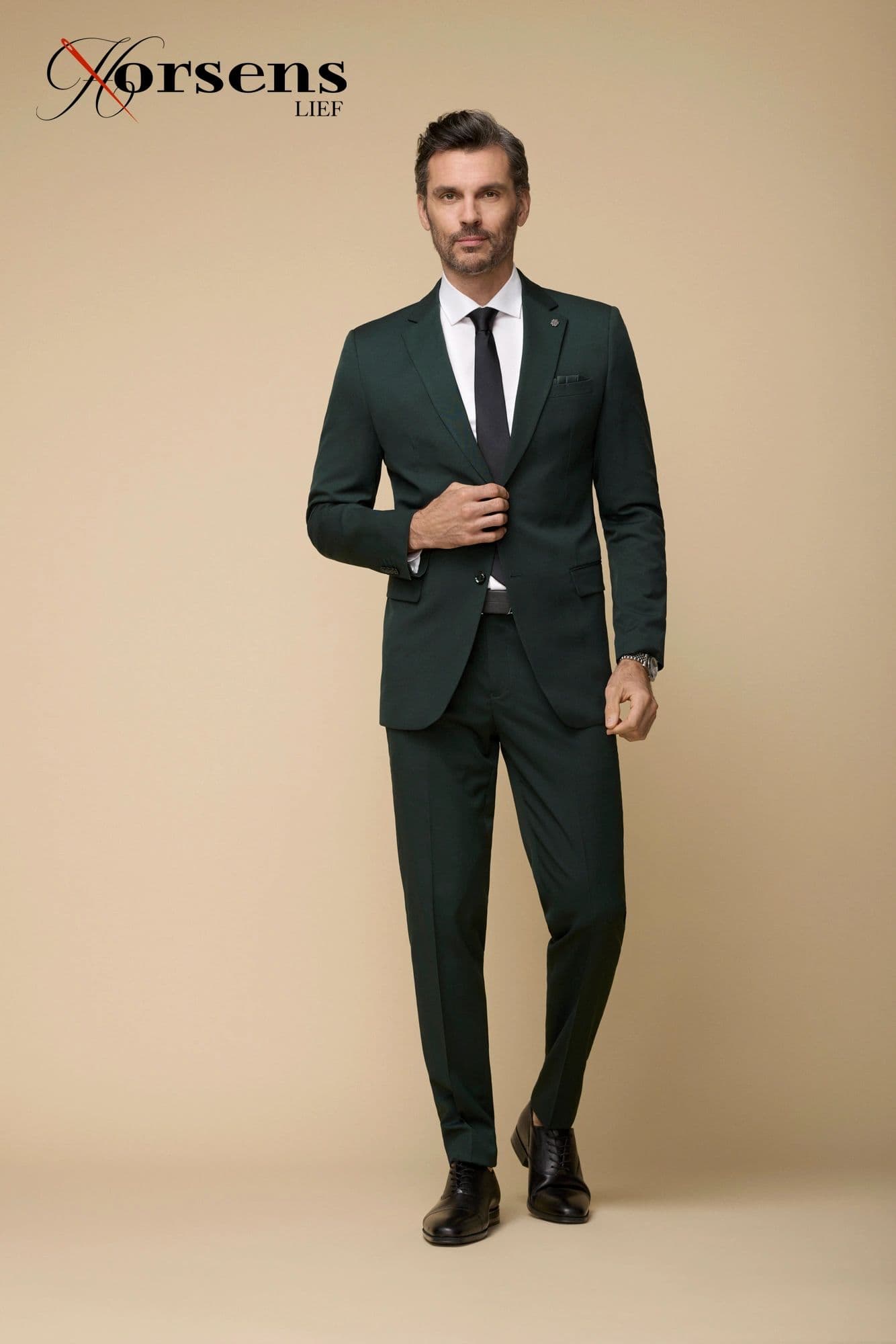 Bottle green suit with a black tie