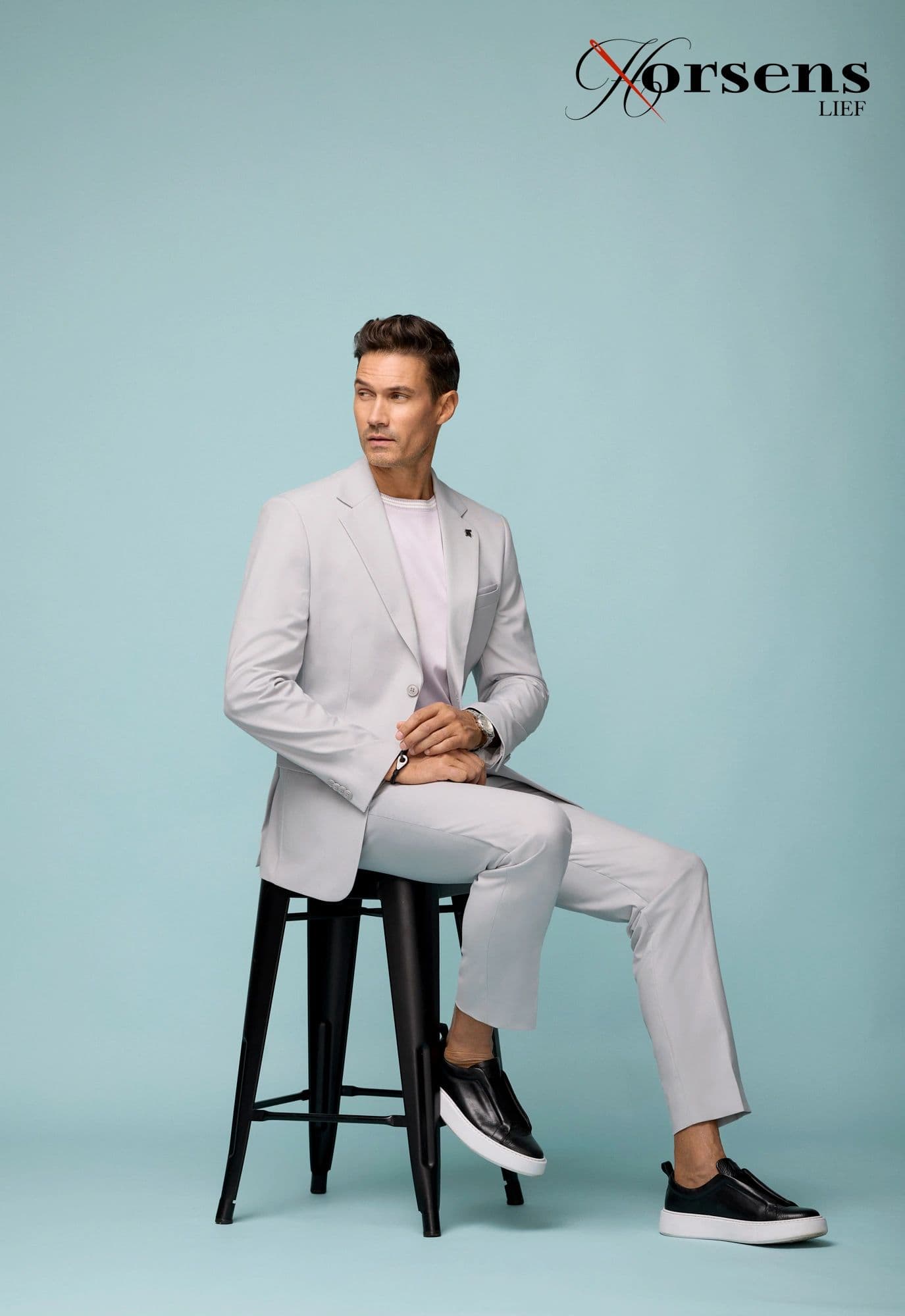 Pale grey suit styled with a tee & sneakers