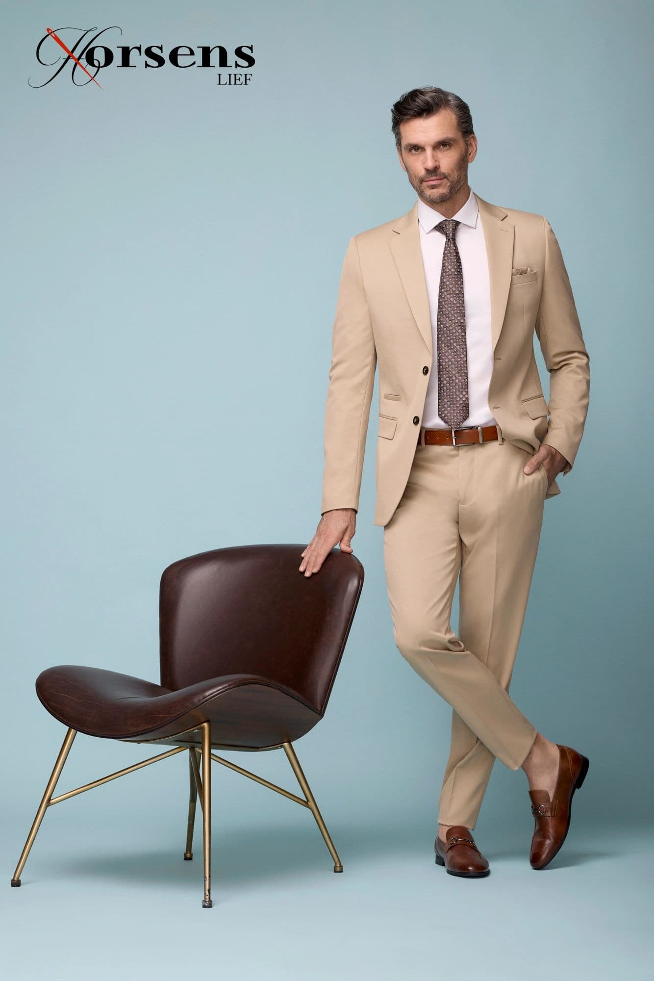 Tan suit with a brown tie