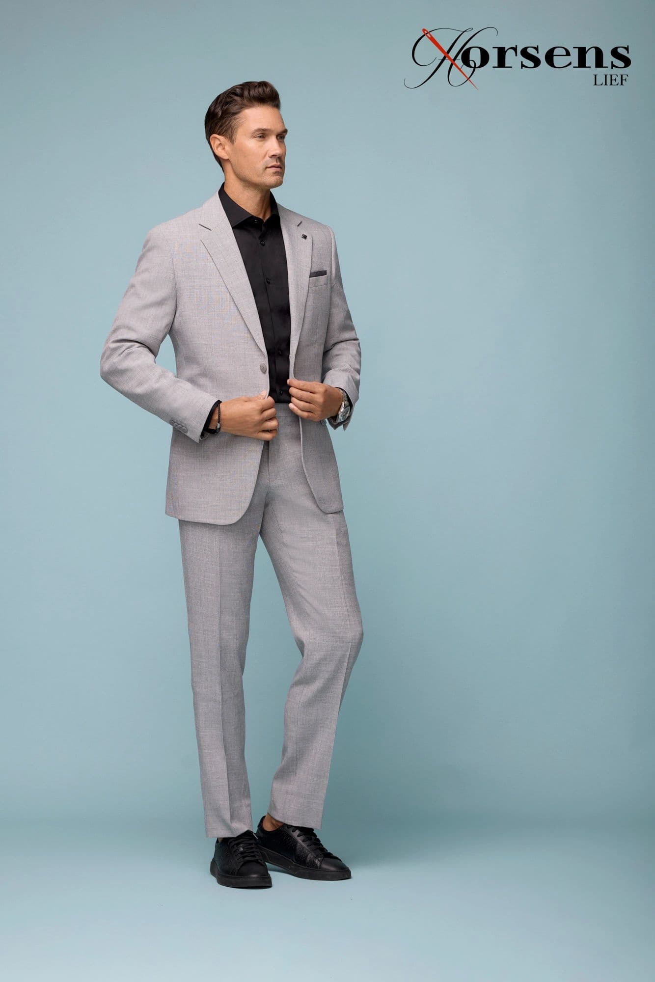 Light grey suit with an open black shirt